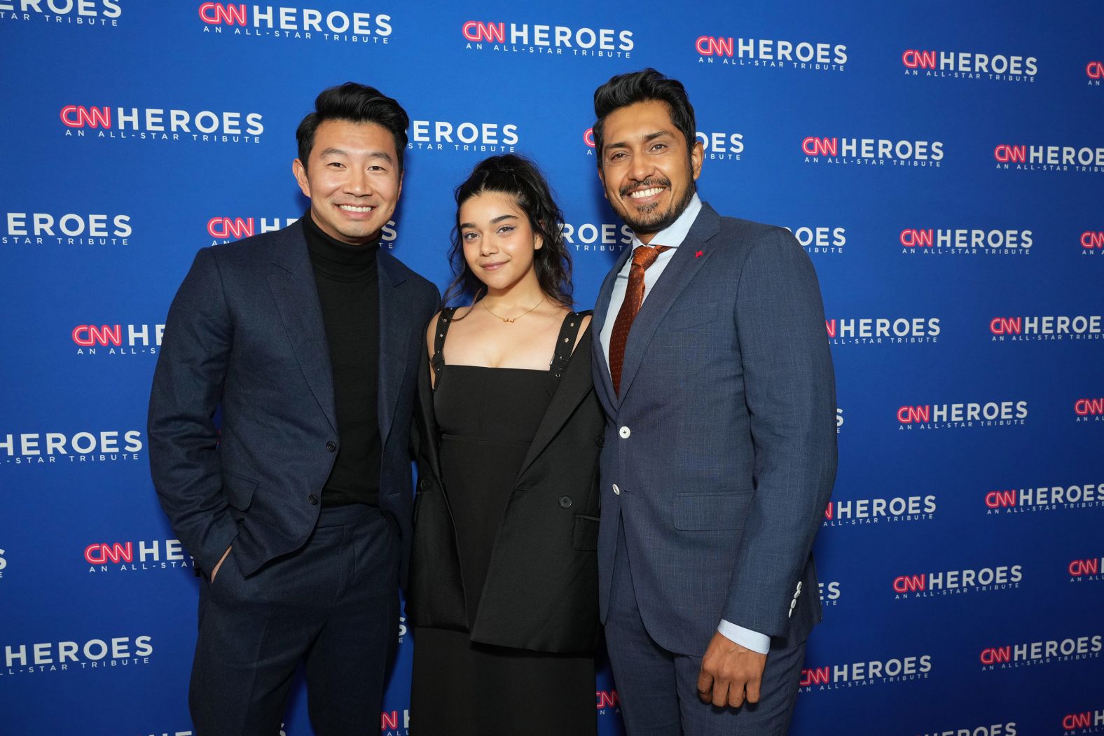 From left, actors Simu Liu, Iman Vellani and Tenoch Huerta pose on the red carpet.