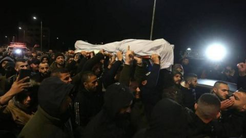 Mourners carry Jana Zakarneh's shroud during her funeral procession. 