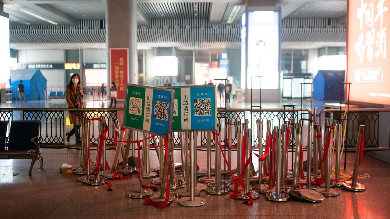 Posters used for health code scanning and barriers used for health screening are seen dismantled at Nanjing South railway station on Friday in Nanjing, China. 