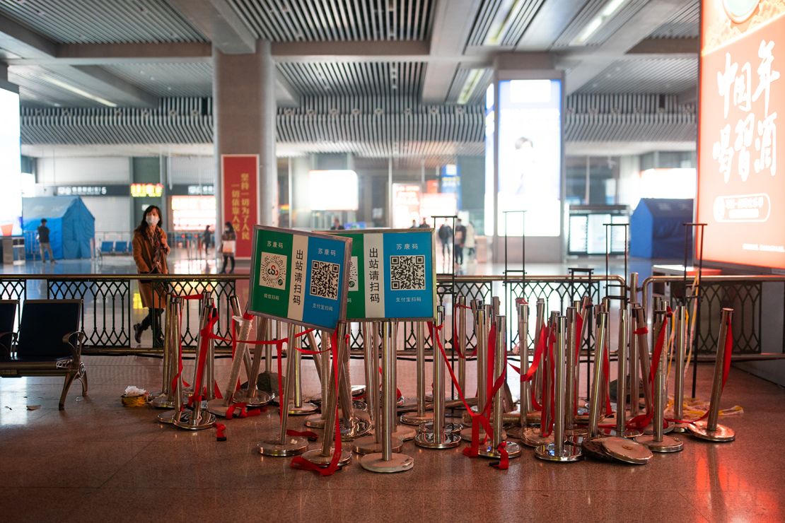 Posters used for health code scanning and barriers used for health screening are seen dismantled at Nanjing South railway station on Friday in Nanjing, China. 