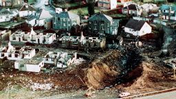 This December 1988 file photo shows wrecked houses and a deep gash in the ground in the village of Lockerbie, Scotland, after the bombing of the Pan Am 103 in the village of Lockerbie, Scotland. 