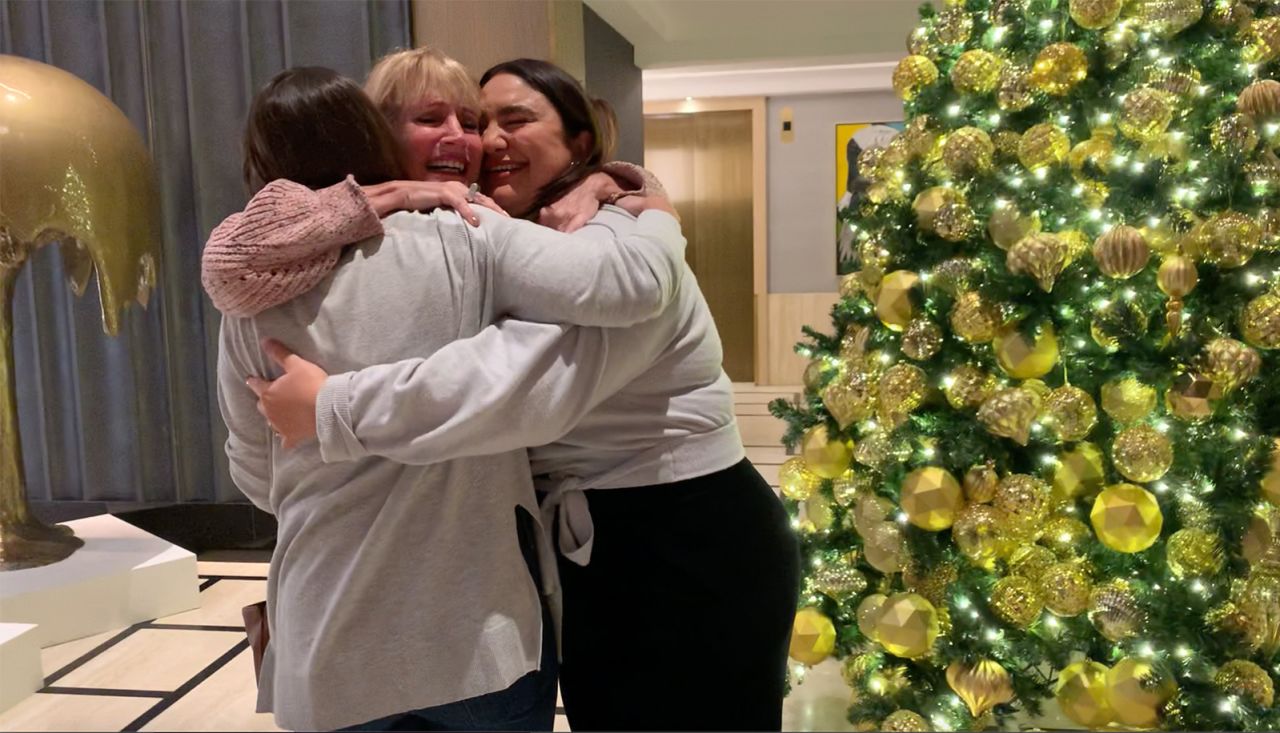 Tracy Peck and the two sisters share a hug in the lobby of their New York hotel. It was the first time they'd seen each other in person in 23 years.
