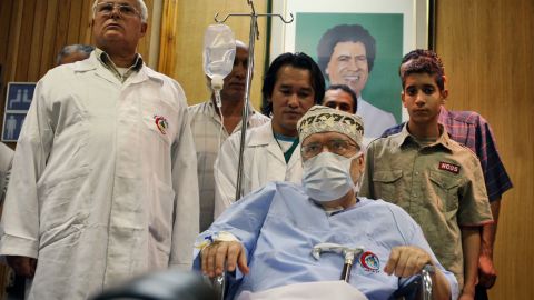 Megrahi is seen below a portrait of Gadhafi at Tripoli Medical Center in Libya