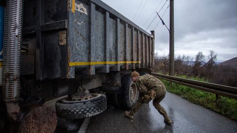  A NATO soldier inspects a truck at a roadblock on one of the main roads to the border crossing point with Serbia on December 11, 2022 near Zubin Potok, Kosovo. 