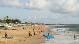Tourists enjoy the popular surf beach at Batu Bolong on December 8, 2022 in Canggu, Bali, Indonesia. 