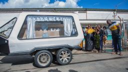 Relatives look at a hearse carrying the remains of Zambian student Lemekhani Nyireda at the Kenneth Kaunda International Airport in Lusaka on December 11, 2022, who died in the conflict in Ukraine last September.