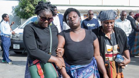 A relative of Lemekani Nyarenda, who was killed in clashes in Ukraine in September, is consoled as his coffin arrives at Kenneth Kaunda International Airport in Lusaka on Sunday.