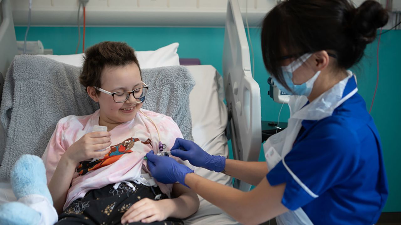 Senior Research Nurse Jan Chu delivers the therapy to Alyssa in May.