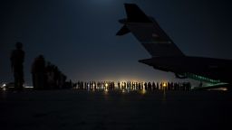 A U.S. Air Force aircrew, assigned to the 816th Expeditionary Airlift Squadron, prepare to load qualified evacuees aboard a U.S. Air Force C-17 Globemaster III aircraft in support of Afghanistan evacuation at Hamid Karzai International Airport, Afghanistan, Aug. 21, 2021. The Department of Defense is committed to supporting the U.S. State Department in the departure of U.S. and allied civilian personnel from Afghanistan, and to evacuate Afghan allies safely. (U.S. Air Force photo by Senior Airman Taylor Crul)