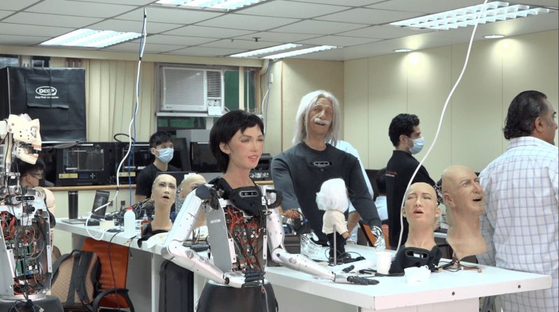 Sophia's "sister" robot Grace has been designed to operate in the healthcare sector. Grace is currently being trialled to support elderly people in the early stages of degenerative brain diseases, such as dementia. Pictured, Grace in the center of the Hanson Robotics lab.