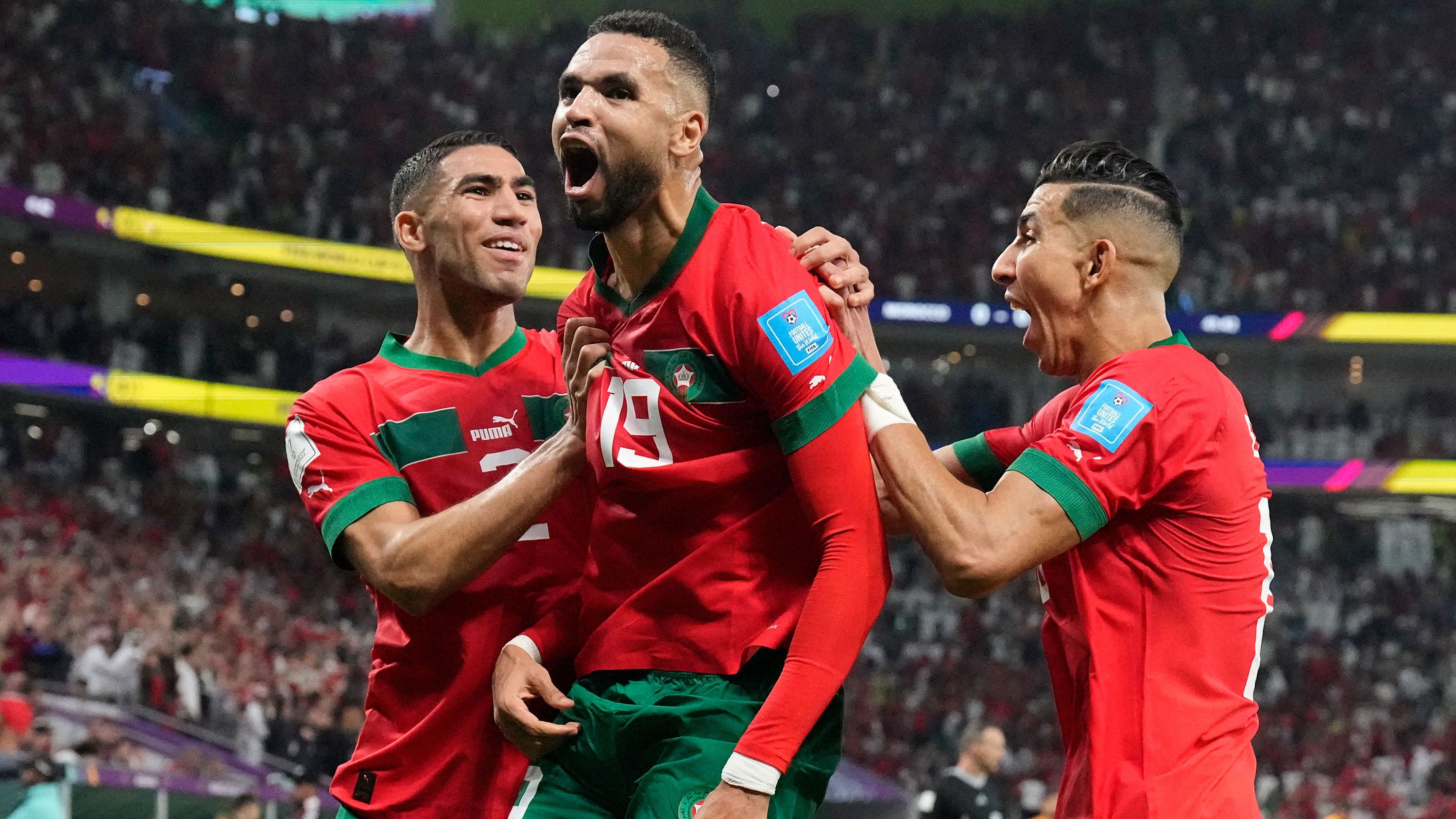 Morocco's Youssef En-Nesyri, center, celebrates after scoring the only goal in his side's World Cup quarterfinal win over Portugal, at Al Thumama Stadium in Doha, Qatar, on December 10, 2022.