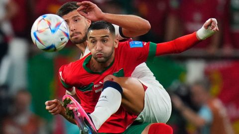 Morocco's Hakim Ziyech fights for the ball with Portugal's Ruben Dias during the quarterfinal that The Atlas Lions won 1-0.