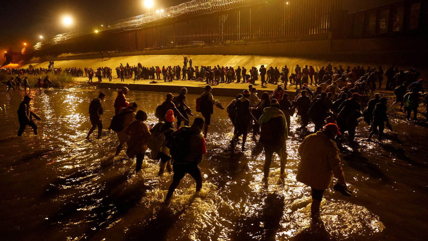 Migrants cross the Rio Bravo to request asylum in El Paso, Texas, on Sunday, December 11.