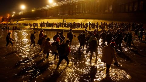 Migrants cross the Rio Grande near El Paso, Texas, on Sunday. Officials say the city is bracing for the end of Title 42 next week.