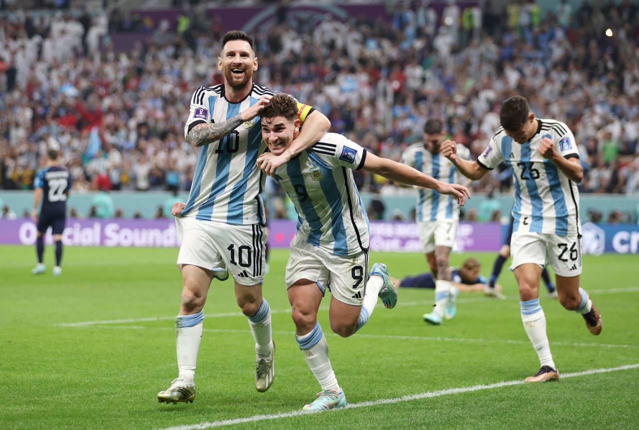 Argentina star Lionel Messi, left, celebrates with teammate Julián Álvarez after Álvarez scored his first of two goals against Croatia in the World Cup semifinals on Tuesday, December 13. Messi scored the other goal on a first-half penalty.