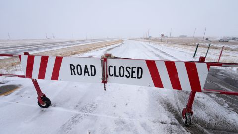 A road closed sign hangs on a shuttered gate on Interstate 70  in Aurora, Colorado, on Tuesday.