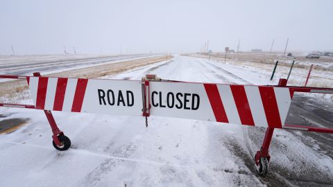 A road closed sign hangs on a shuttered gate on Interstate 70 in Aurora, Colorado, on Tuesday.