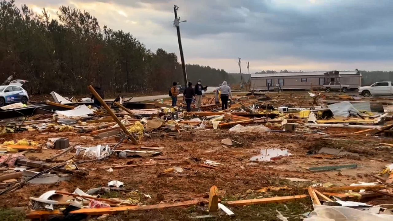 People inspect debris at a mobile home park in the Farmerville area of Union Parish, Louisiana, on Wednesday.