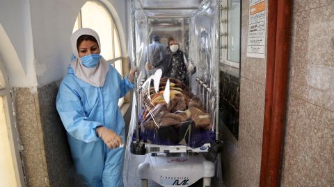 Medical workers transport a patient with Covid-19 at Rasoul Akram Hospital in Tehran on October 20, 2020.