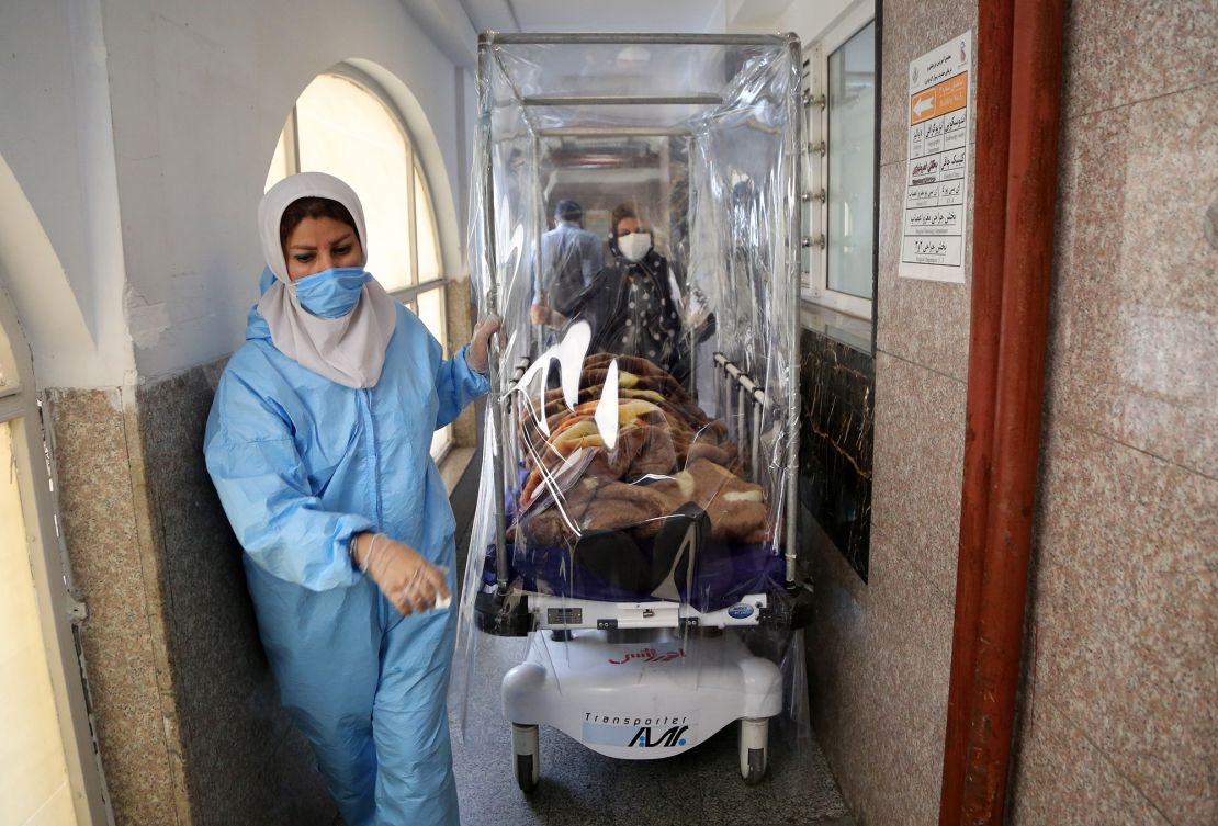 Medical workers transport a patient with Covid-19 at Rasoul Akram Hospital in Tehran on October 20, 2020. 