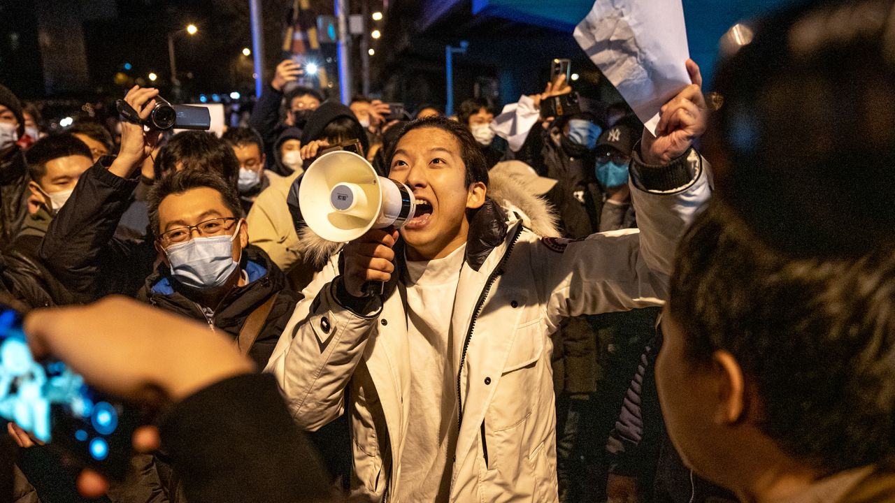 A demonstrator holds a blank sign and chants slogans during a protest in Beijing, China, on Monday, November 28, 2022.