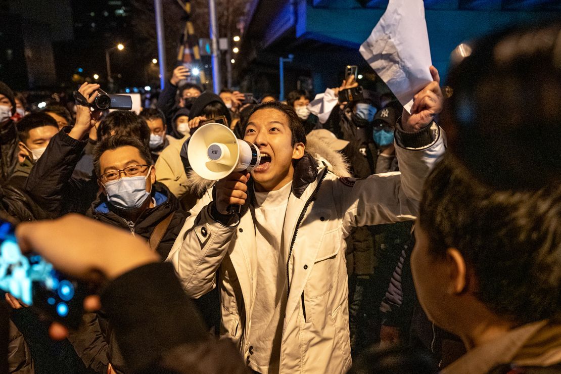 A demonstrator holds a blank sign and chants slogans during a protest in Beijing, China, on Monday, November 28, 2022.