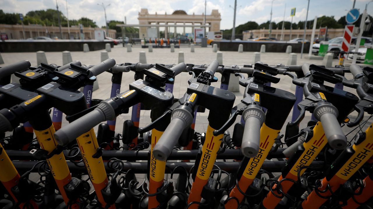 Electric scooters are parked at a station in Moscow in June 2021. 