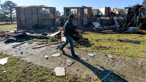Police official surveys the damage to one of the buildings in an apartment complex, after a small tornado hit Eutaw, Alabama, on November 29, 2022.  