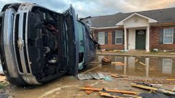 A truck lies on its side Wednesday, December 14, 2022, after a tornado struck Farmerville, Louisiana. At least 20 people were injured when the tornado swept through on Tuesday night.