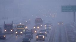 Cars drive north on I-15 after an overnight storm in Lehi, Utah on December 13, 2022. - A cross-country storm is expected to unleash blizzard conditions in the northern US and severe weather in the South and move towards the Northeast later in the week. (Photo by GEORGE FREY / AFP) (Photo by GEORGE FREY/AFP via Getty Images)