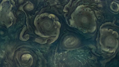 Jupiter's northernmost cyclone, visible along the bottom of the image to the right, was captured by Juno.
