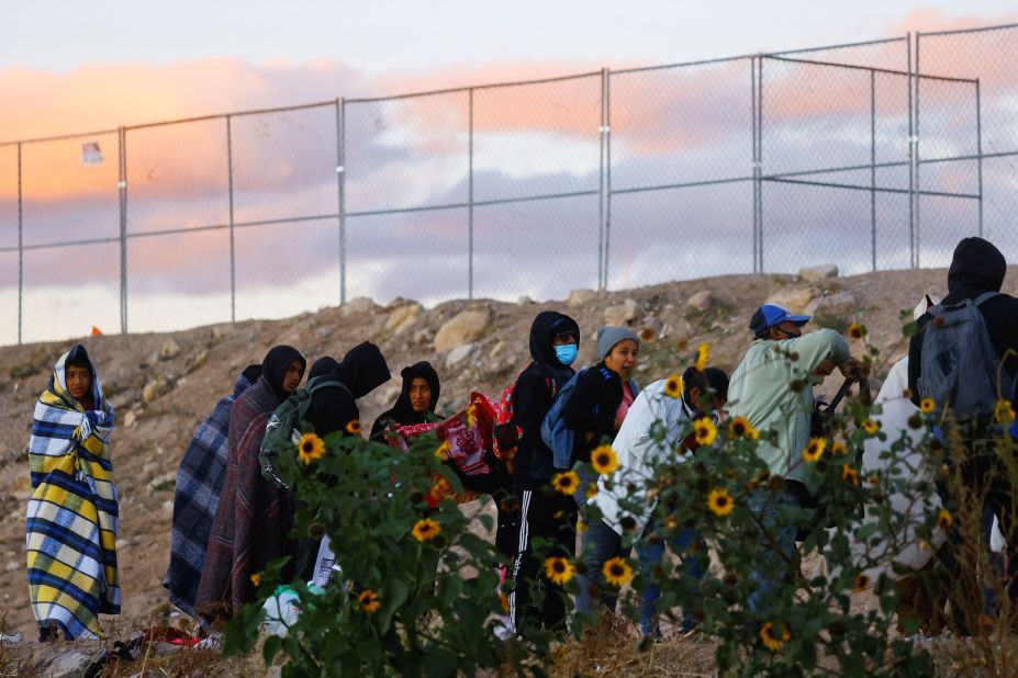 Migrants walk near the border wall between Ciudad Juarez and El Paso on December 13.