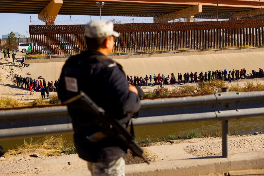 A member of the Mexican army watches migrants on December 12.