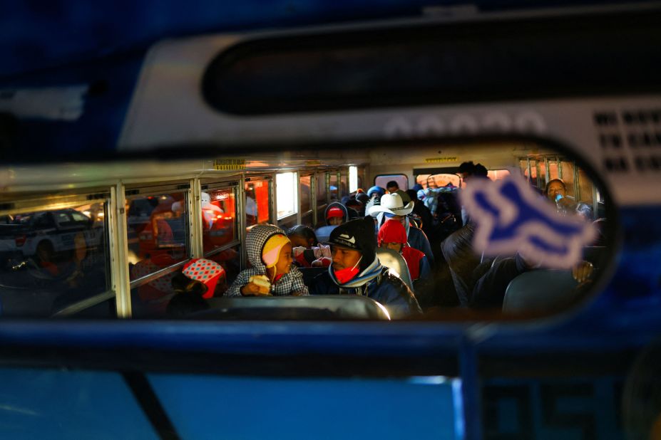 Migrants ride a bus on their way to the United States to request asylum on December 11.