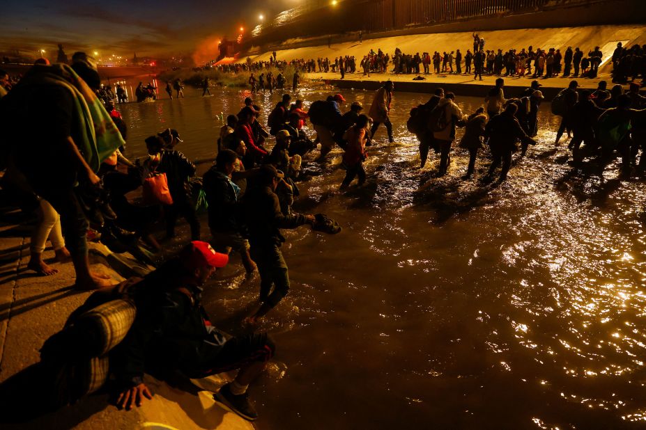 Migrants cross the Rio Grande on December 11.