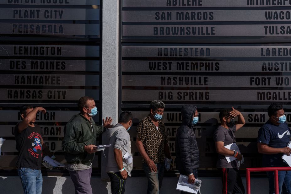 Migrants line up at the entrance of a bus station in El Paso on December 12.
