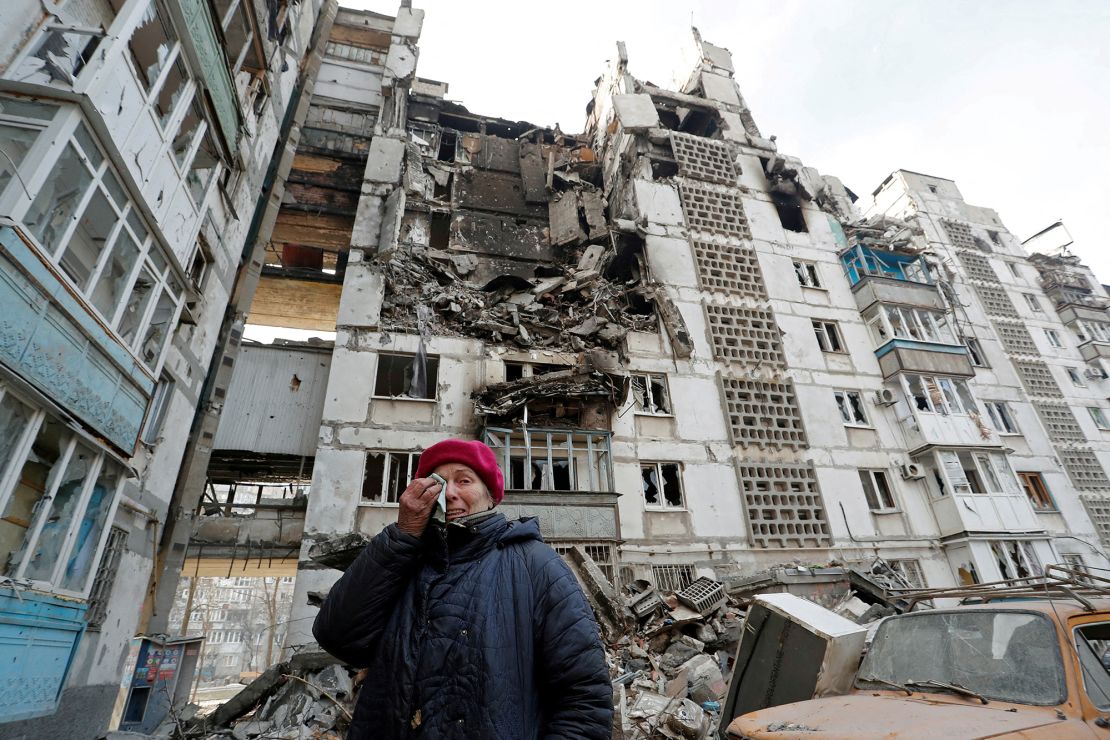 Local resident Valentina Demura, 70, stands next to the building where her destroyed apartment is located in the southern port city of Mariupol.