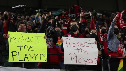 Portland Thorns fans hold signs during the first half of the team's National Women's Soccer League soccer match against the Houston Dash in Portland, Oregon, on October 6, 2021.