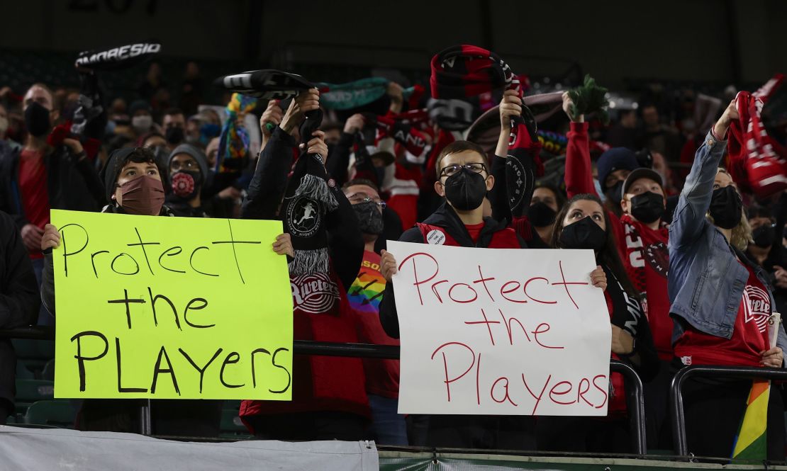 Portland Thorns fans hold signs during the first half of the team's National Women's Soccer League soccer match against the Houston Dash in Portland, Oregon, on October 6, 2021.