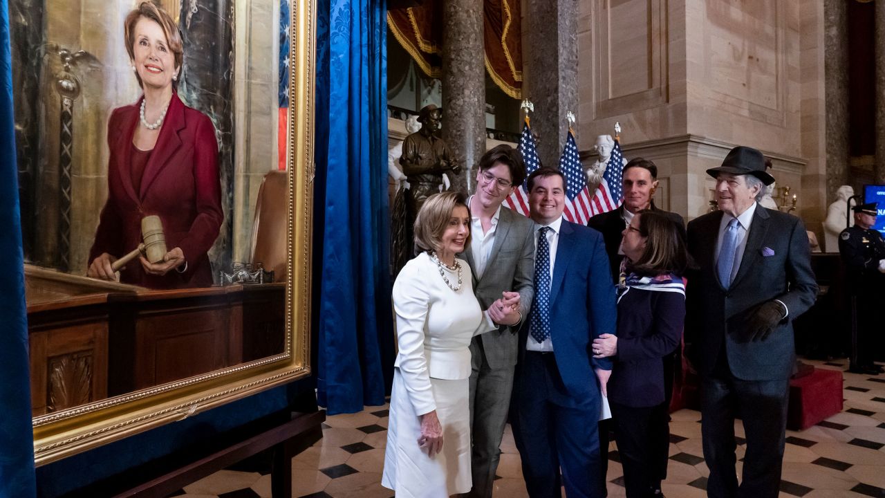 Speaker of the House Nancy Pelosi is joined by her family and husband Paul Pelosi, far right, as they attend her portrait unveiling ceremony in Statuary Hall at the Capitol in Washington, December 14, 2022. 