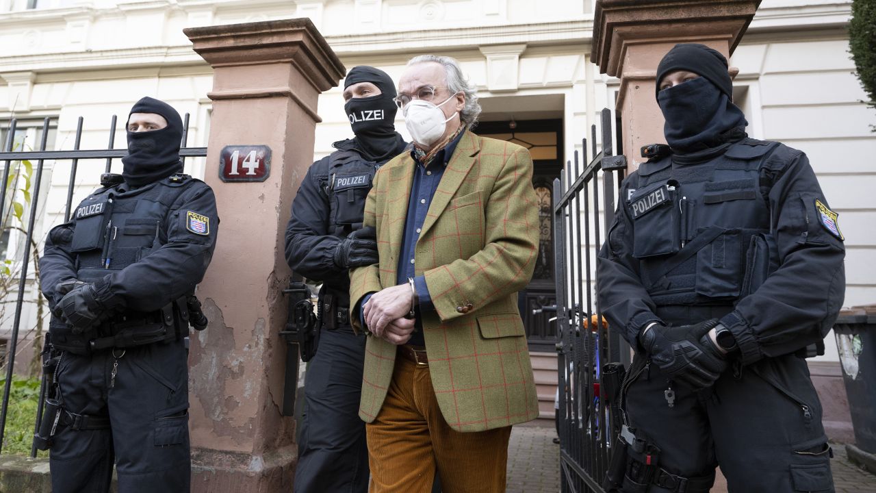 Heinrich XIII Prince Reuss is lead away by police after a raid in Frankfurt on December 7.