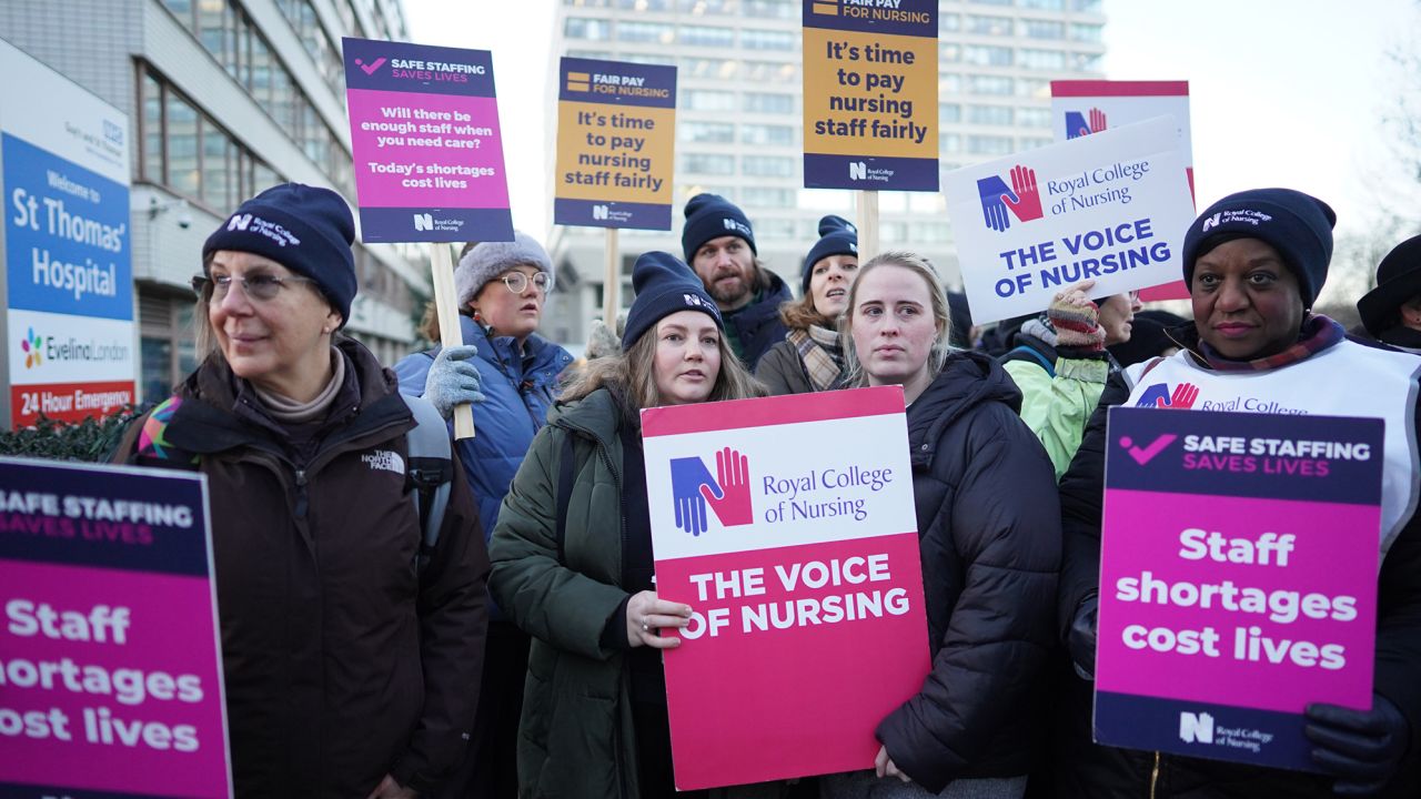 Members of the Royal College of Nursing stand on a picket line outside St. Thomas' Hospital in London on Thursday December 15, 2022. 