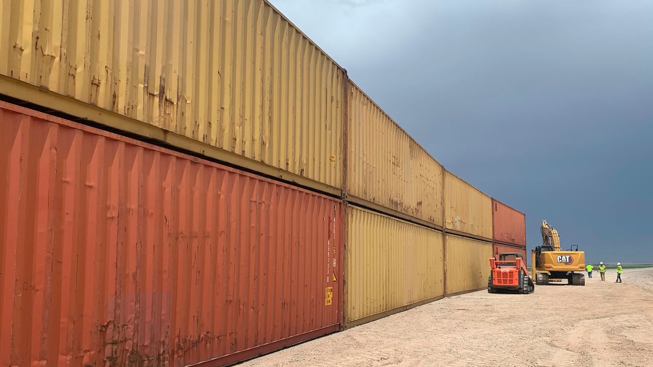 This photo provided by the Arizona Governor's Office shows shipping containers that will be used to fill a 1,000 foot gap in the border wall with Mexico near Yuma, Arizona, on August 12, 2022. 