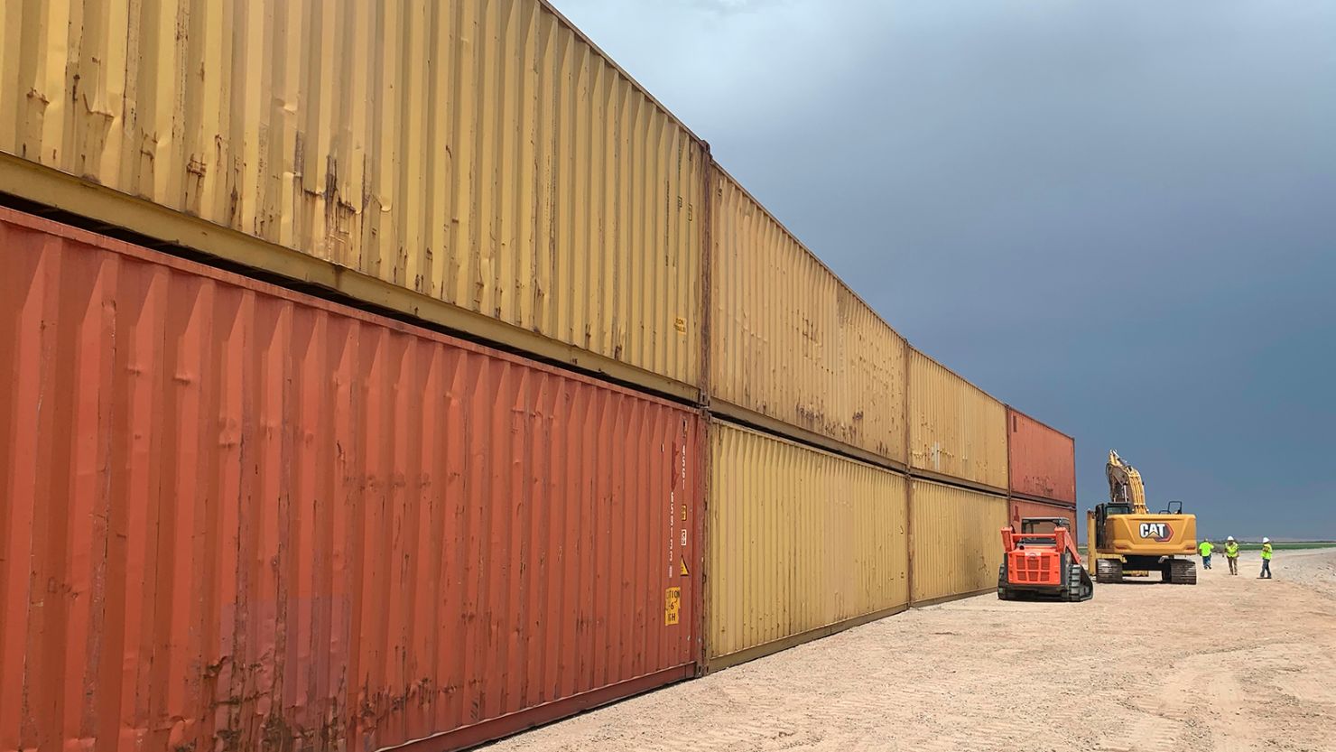 This photo provided by the Arizona Governor's Office shows shipping containers that will be used to fill a 1,000 foot gap in the border wall with Mexico near Yuma, Arizona, on August 12, 2022. 