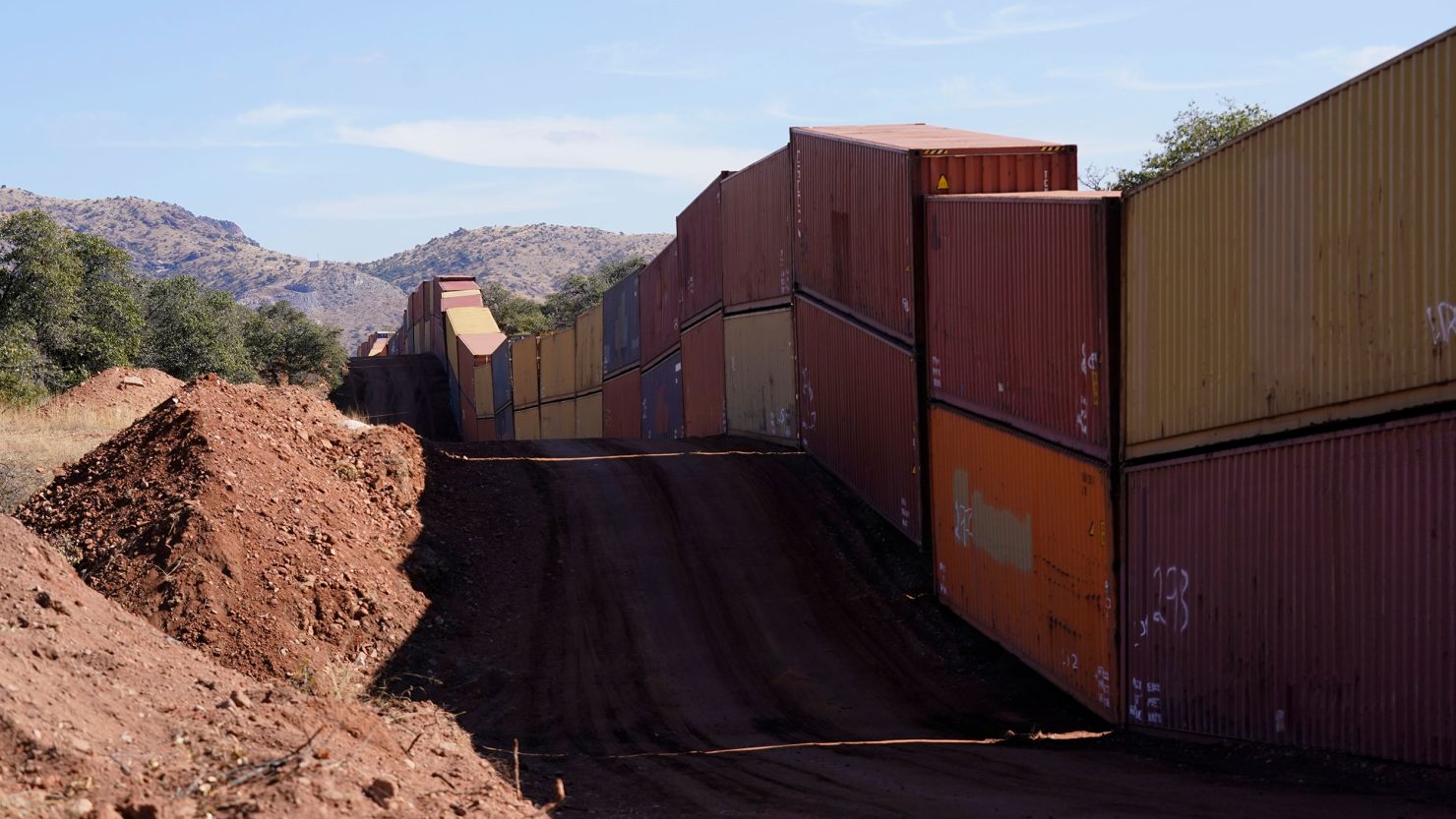 A long row of double-stacked shipping contrainers provide a new wall between the United States and Mexico in the remote section area of San Rafael Valley, Arizona, on December 8, 2022.
