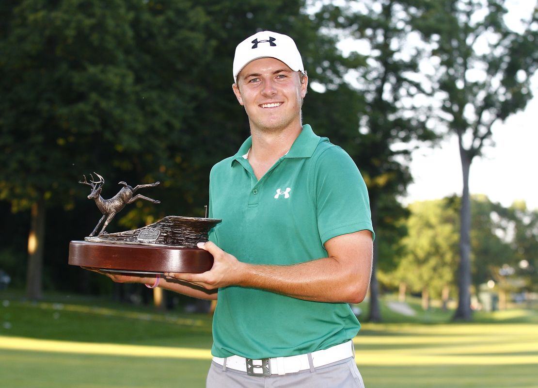Spieth holds the John Deere Classic trophy aloft after victory in July 2013.