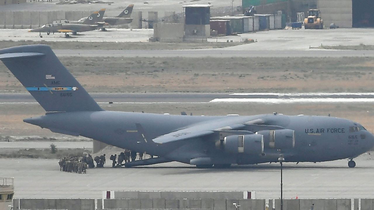 US soldiers board an US Air Force aircraft at the airport in Kabul on August 30, 2021.