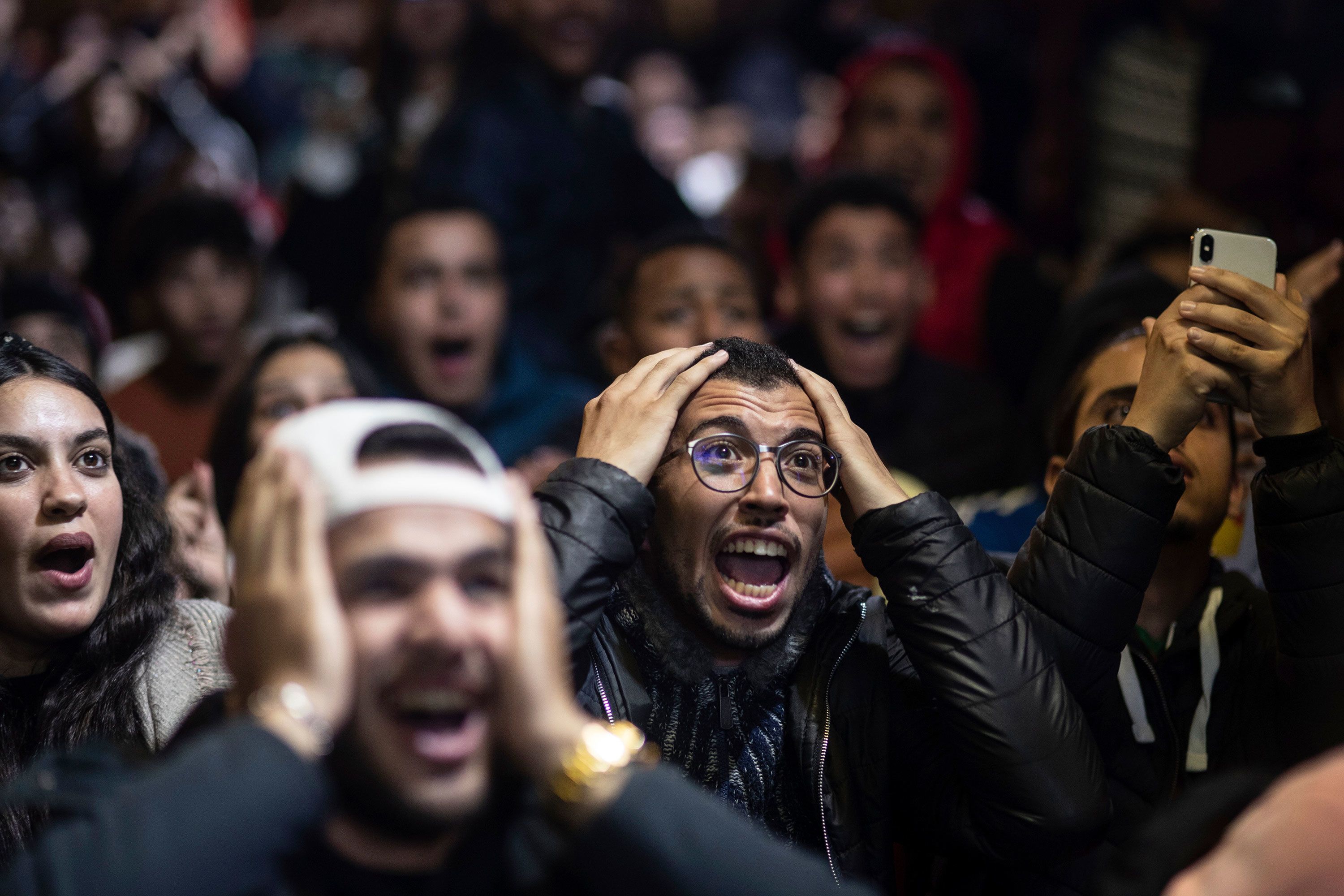 Fans react in Rabat, Morocco, while watching their national team play France in the World Cup semifinals on Wednesday, December 14.