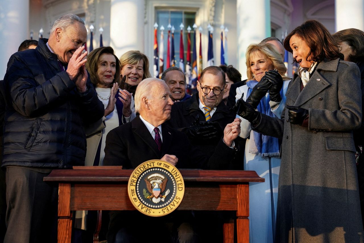 US President Joe Biden hands a pen to Vice President Kamala Harris on Tuesday, December 13, after <a href="https://www.cnn.com/2022/12/13/politics/white-house-same-sex-marriage-signing-ceremony/index.html" target="_blank">signing new federal protections for same-sex and interracial couples</a>. He signed the Respect for Marriage Act before thousands of invited guests on the South Lawn of the White House.