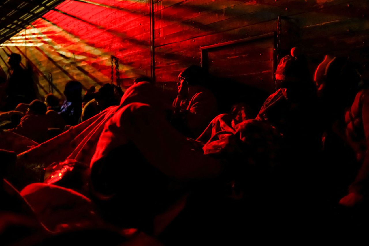 Migrants in Chihuahua, Mexico, ride aboard a box trailer as they travel to the US border on Saturday, December 10.